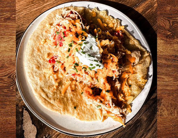 These Citrust Chicken Tacos are loaded with flavor and texture. The taco lays open with meat, cheese and sour cream piled on top.