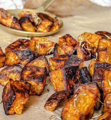 Cubed, oven roasted sweet potatoes garnished with salt.