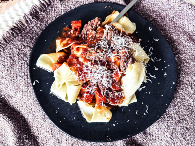 A close-up of beef ragu showcasing the primary ingredients and visualt elements.