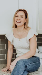 Anna sitting on a countertop smiling