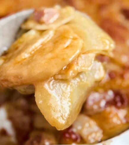 A spoon of scooped Potatoes and Ham